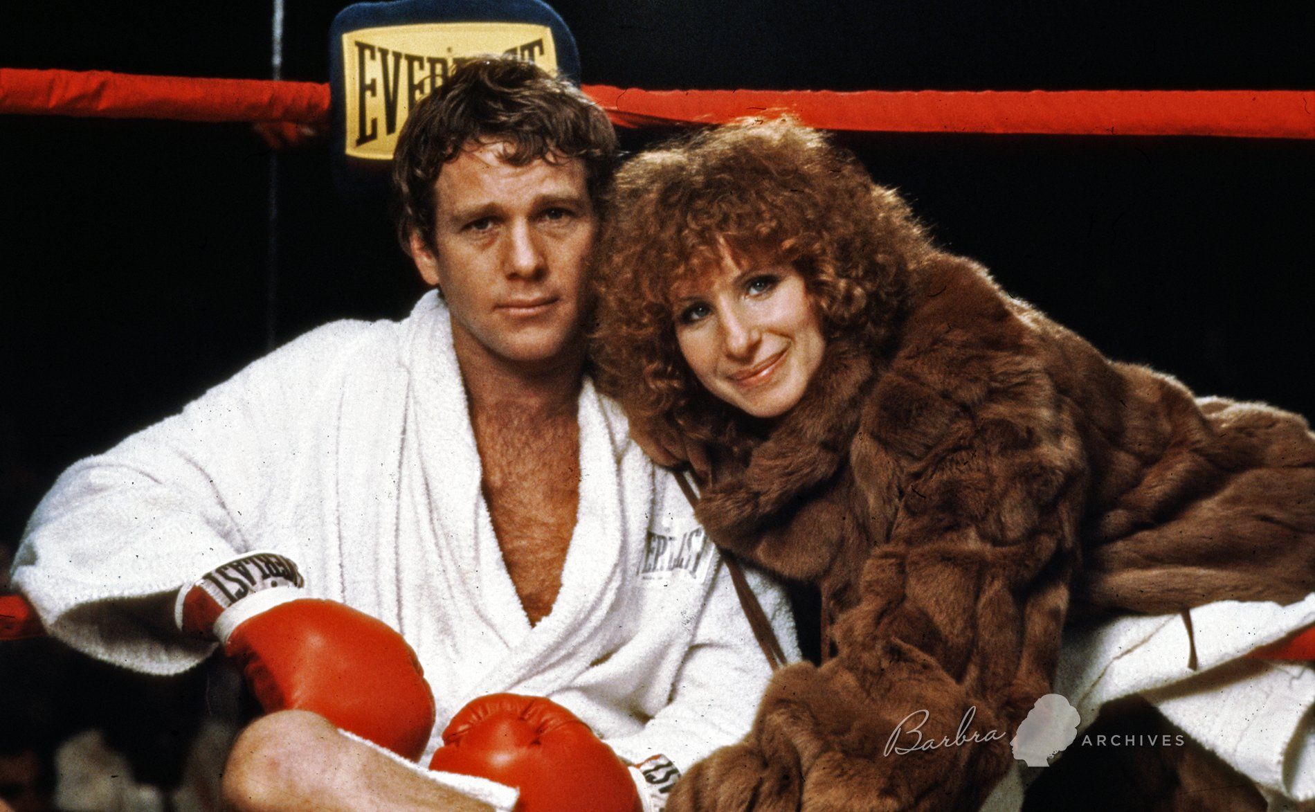 Ryan O'Neal and Barbra Streisand in the boxing ring.