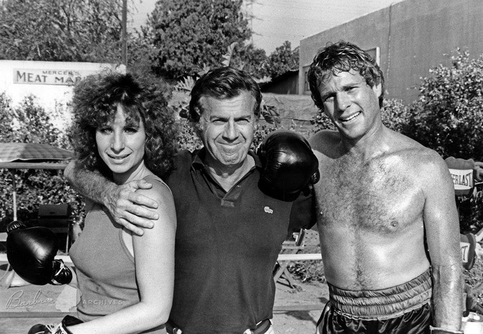 Streisand, Zieff, and O'Neal in the boxing ring.