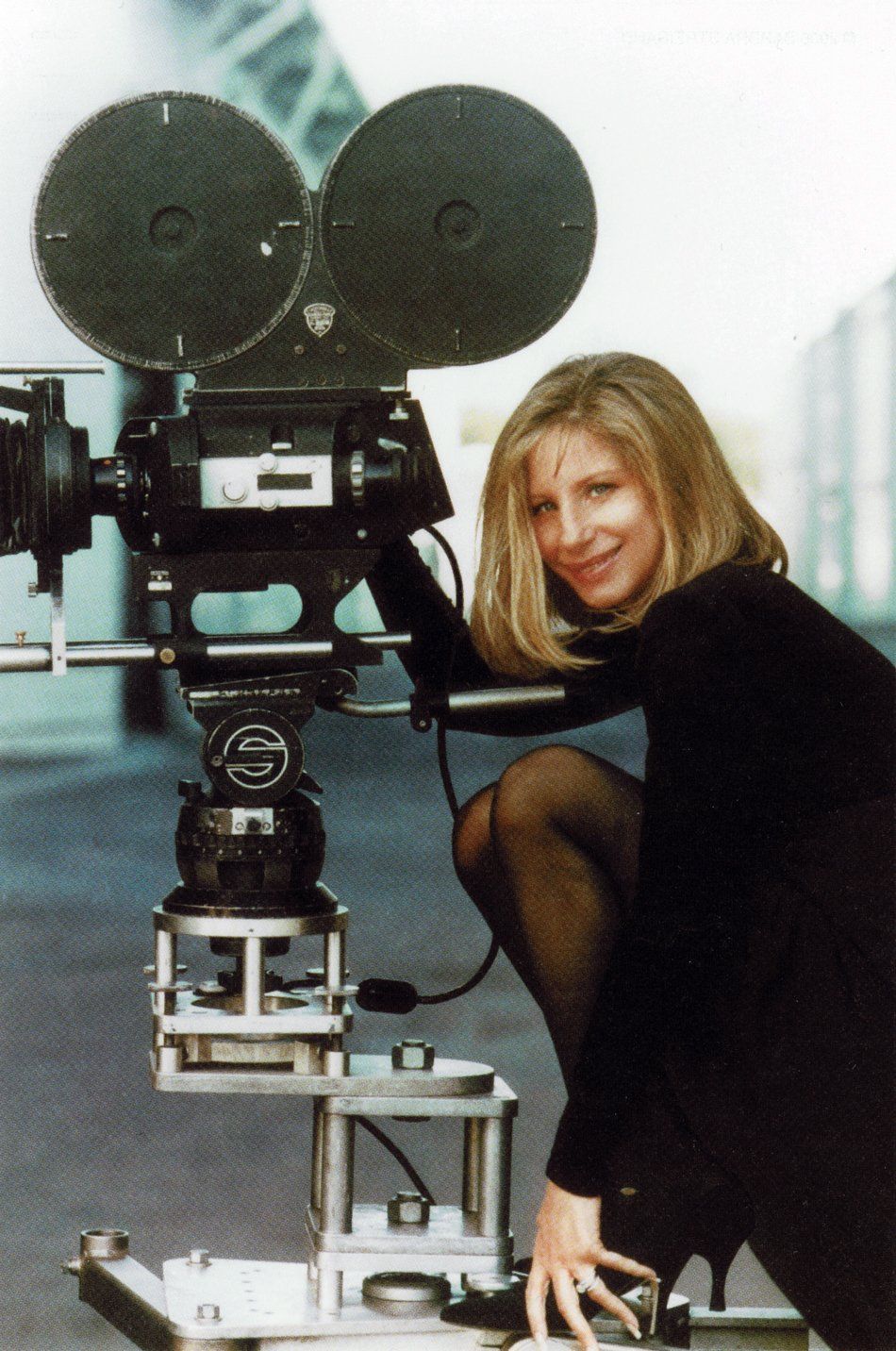 Streisand posing with a film camera