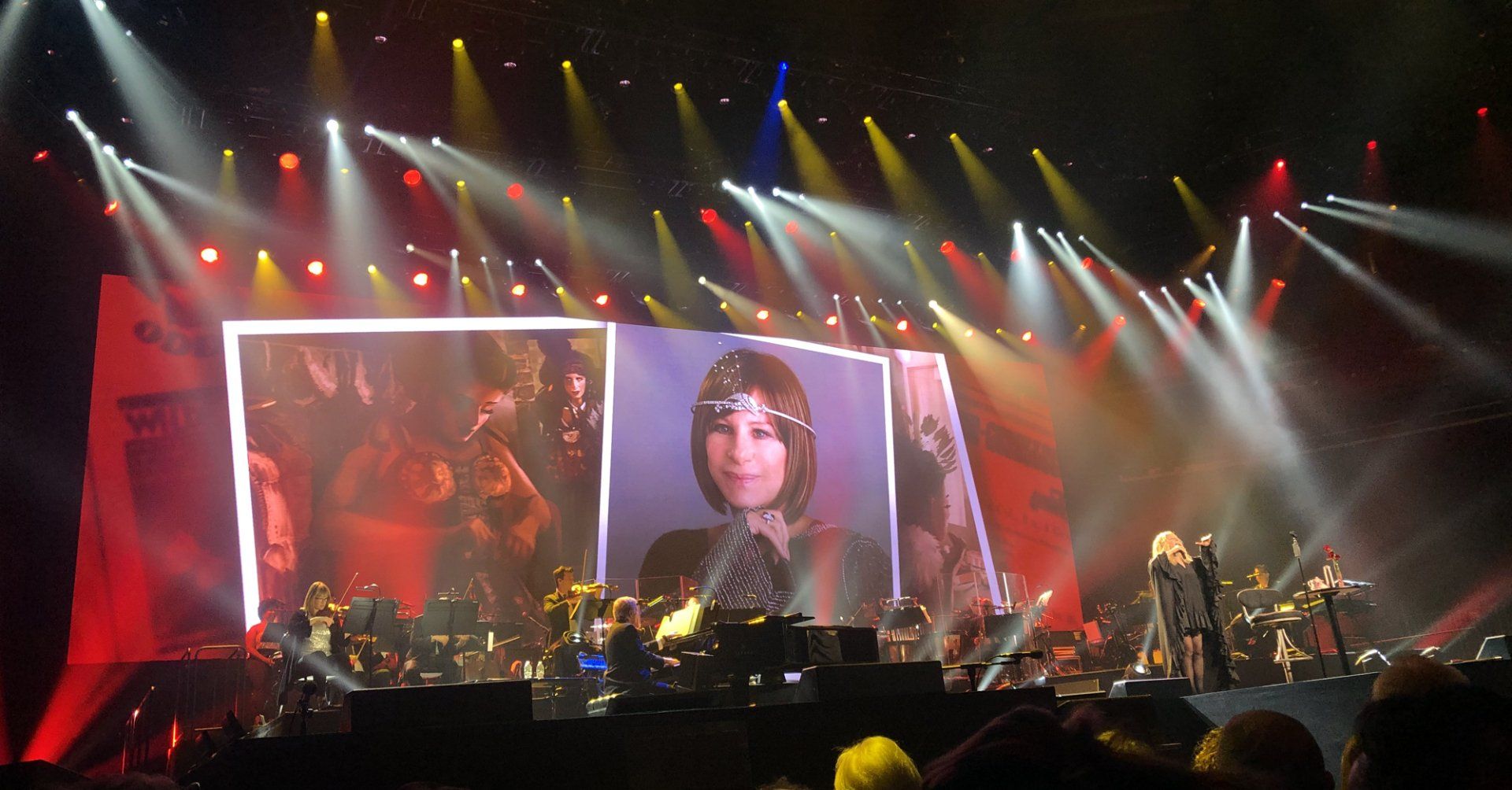 Streisand with her Gypsy costume tests projected on the screen behind her.