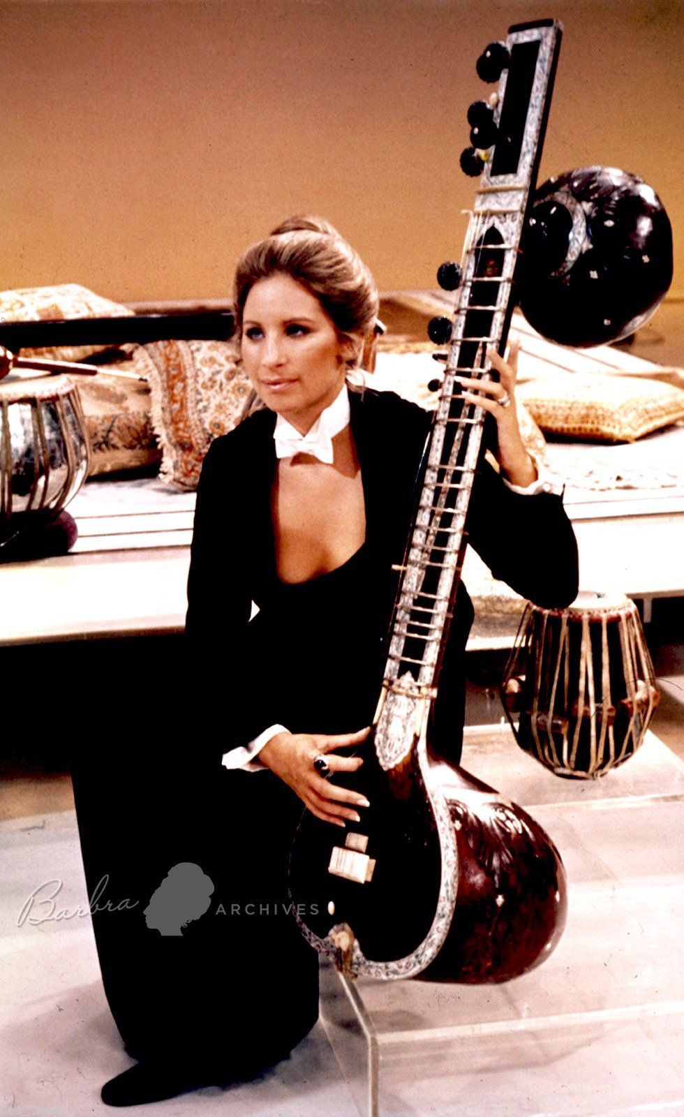 Streisand holds a musical instrument