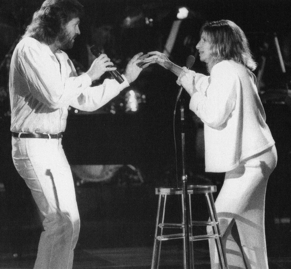 Barry Gibb and Barbra Streisand singing together.