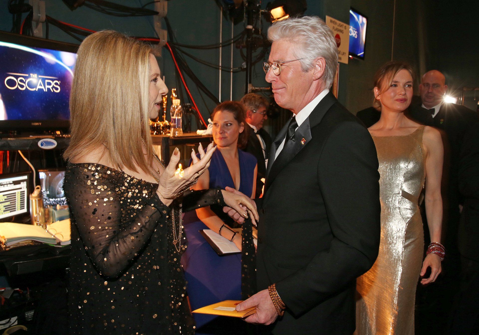 Streisand chats with Richard Gere backstage at the Oscar television show.