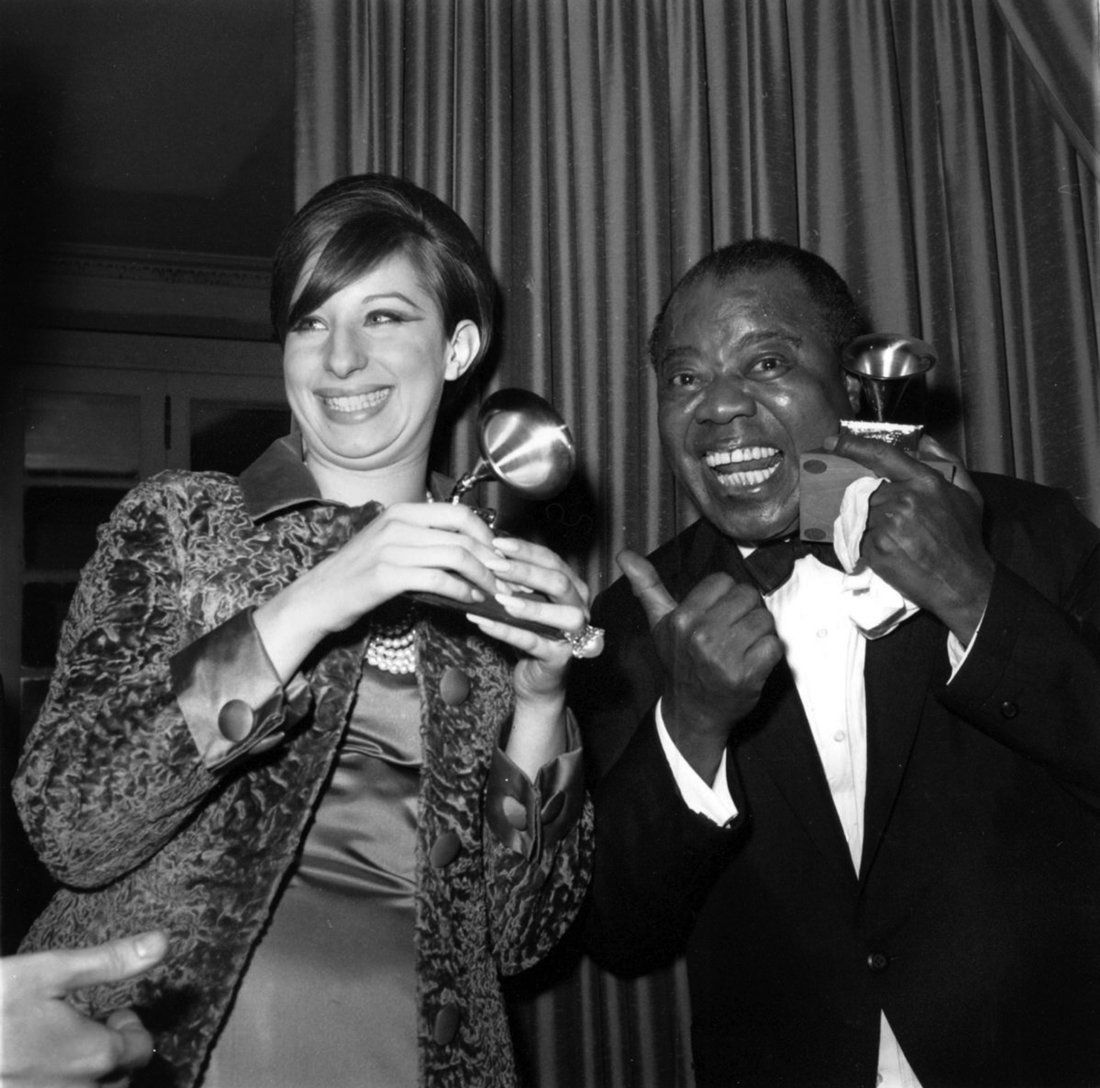 Barbra Streisand and Louis Armstrong hold their Grammy Awards