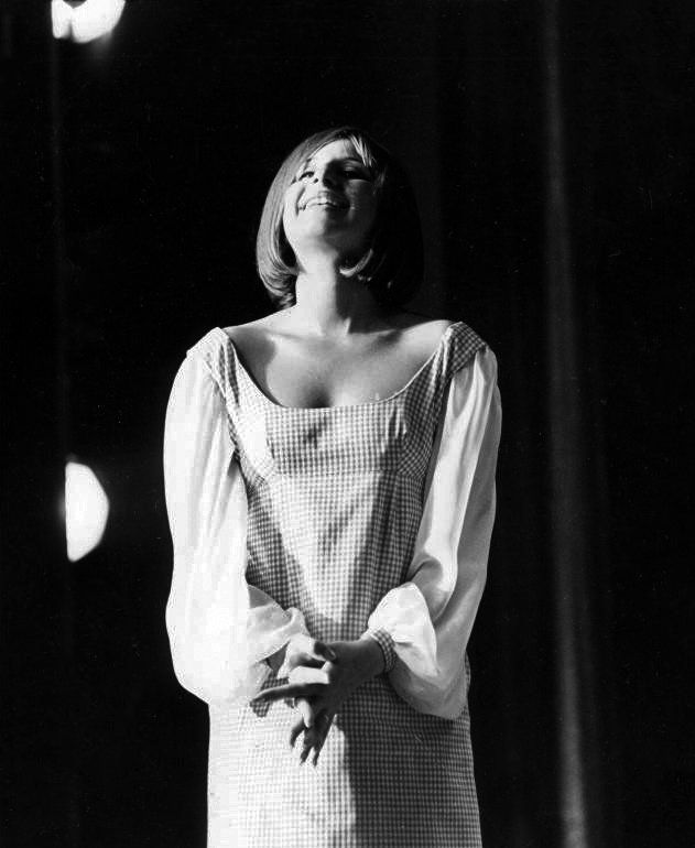 Photo of Barbra Streisand on stage in her gingham dress