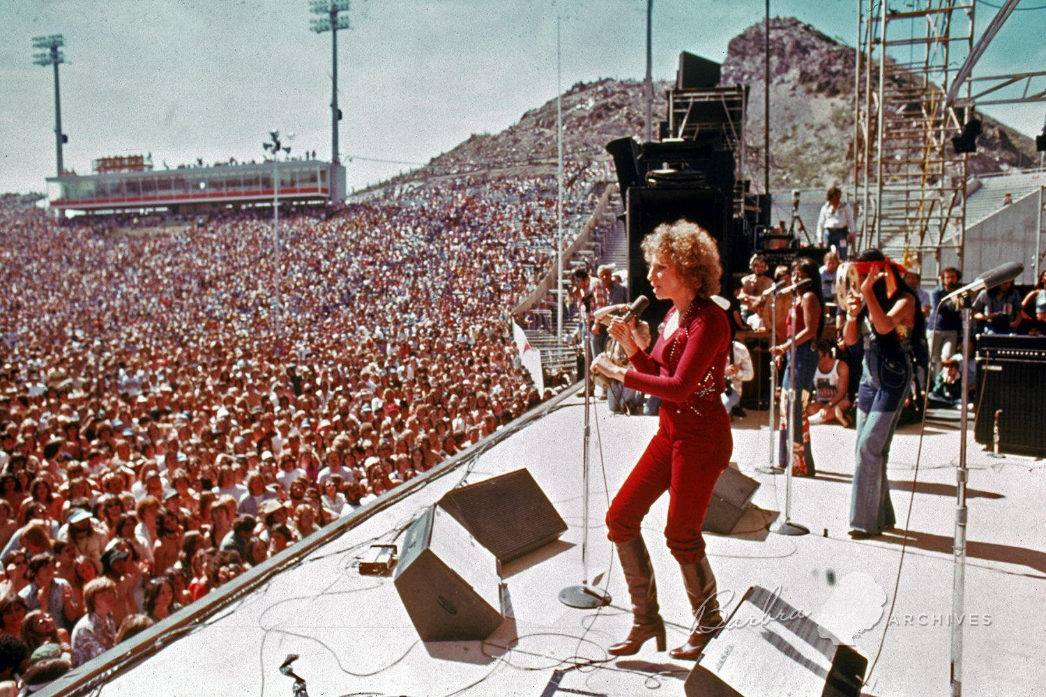 Barbra Streisand on stage in front of thousands of people at Sun Devil Stadium, Arizona.