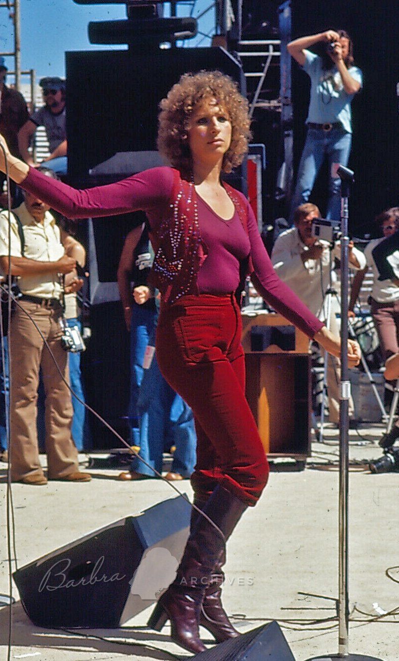 Streisand dressed in maroon top.