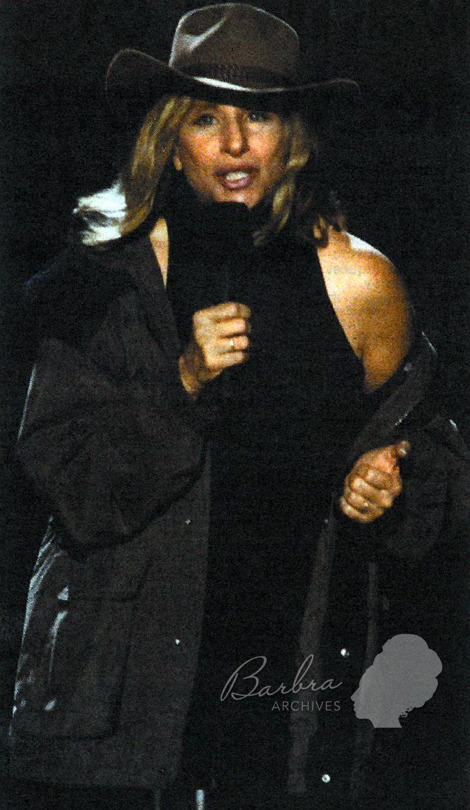 Streisand wearing a brown Akubra hat during a rainstorm in Sydney Australia.