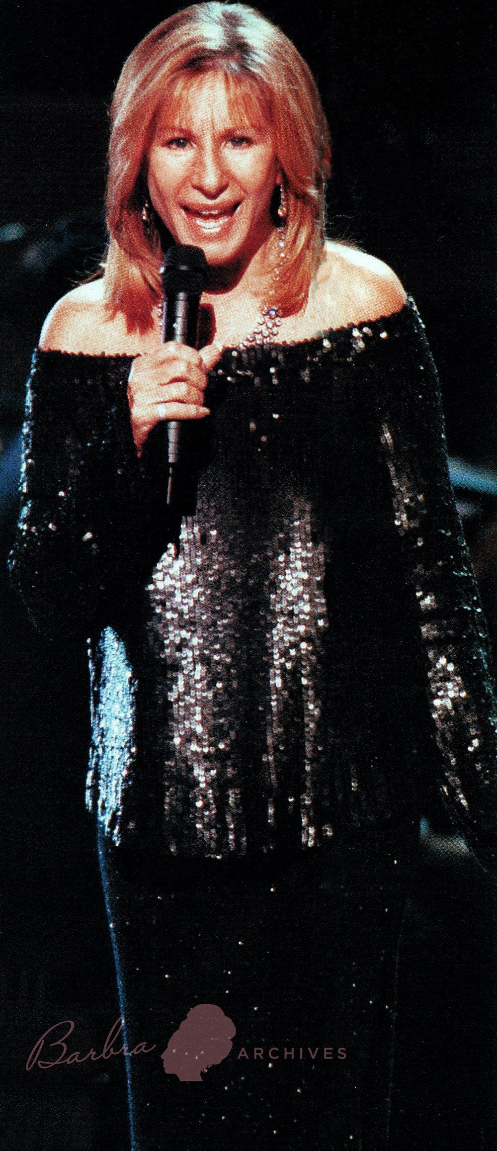 Streisand sings in sparkly off-the-shoulder top in the second act.