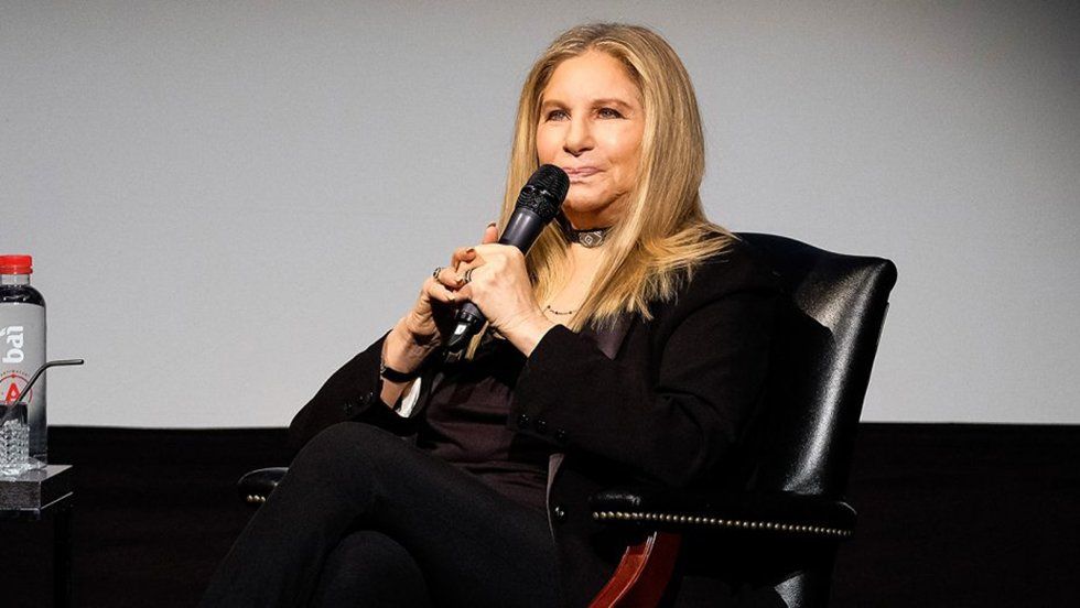 Barbra Streisand on Tribeca stage with microphone.
