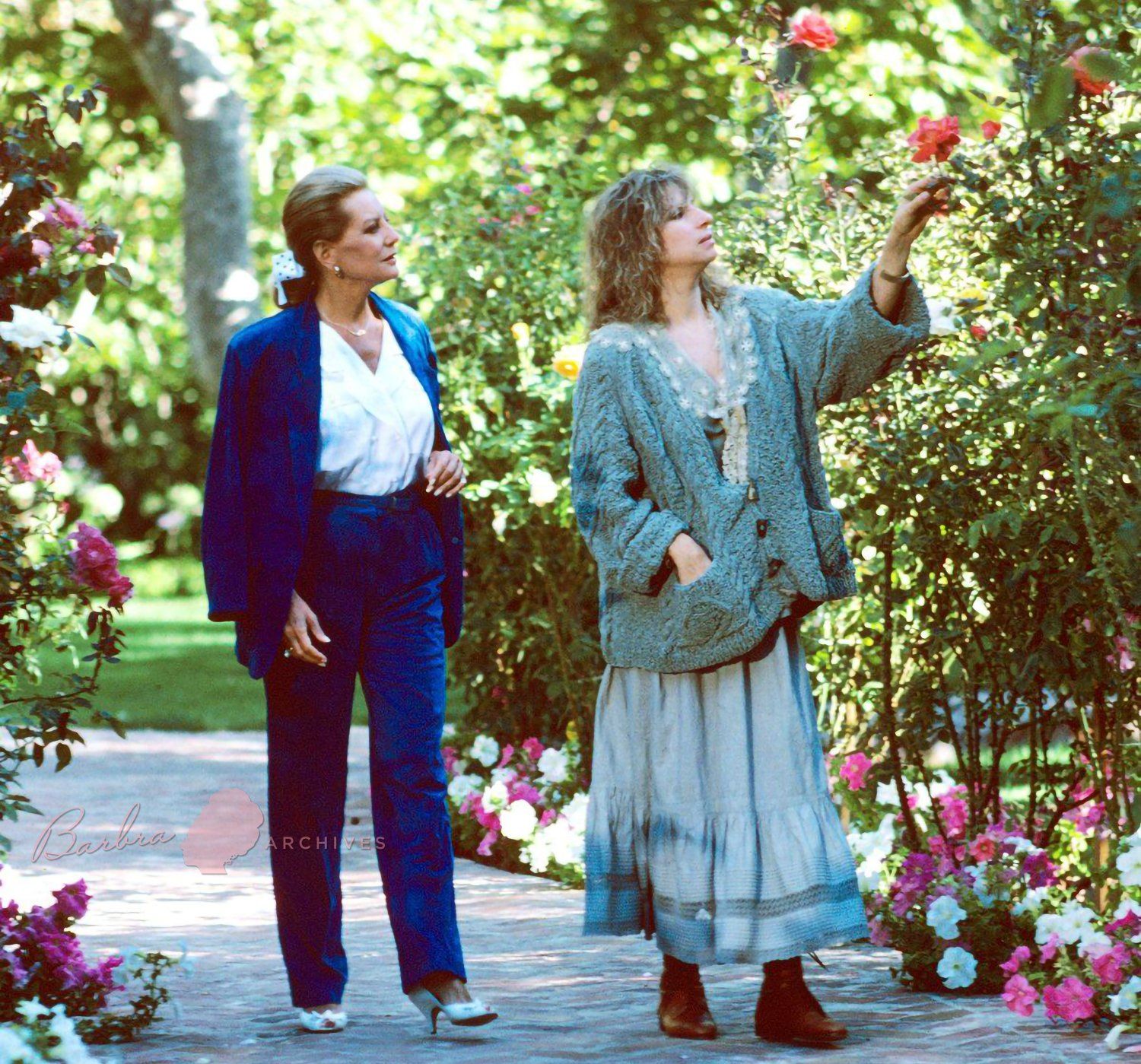 Barbara Walters and Barbra Streisand walk through Streisand's Malibu ranch.