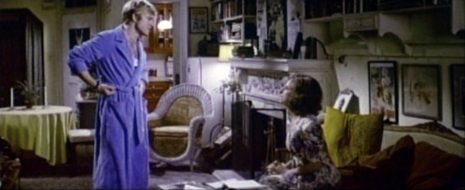 Hubbell and Katie, in bathrobes, talk about Hubbell's writing.
