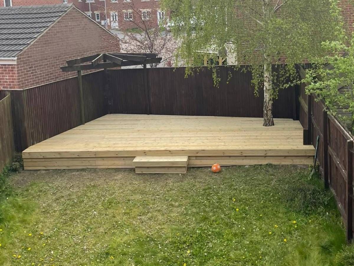 concrete block retaining wall with wooden fencing top in a Leeds garden