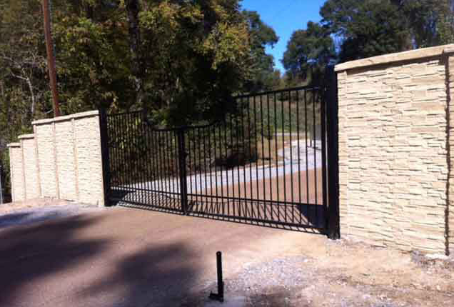 stone fence with wrought iron gate