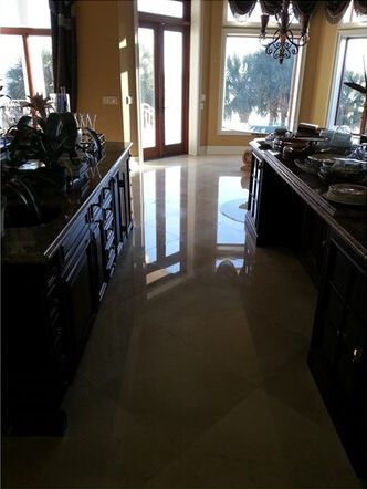 A kitchen with a long counter and a chandelier