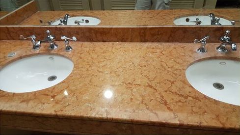 A bathroom with two sinks and a mirror.