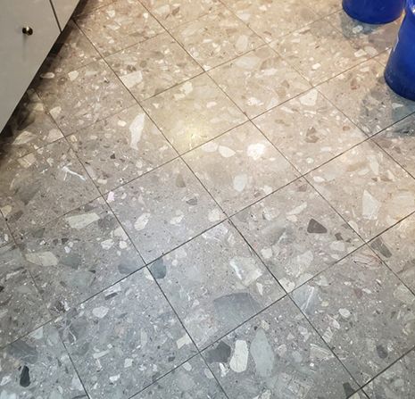 A close up of a tiled floor in a kitchen.