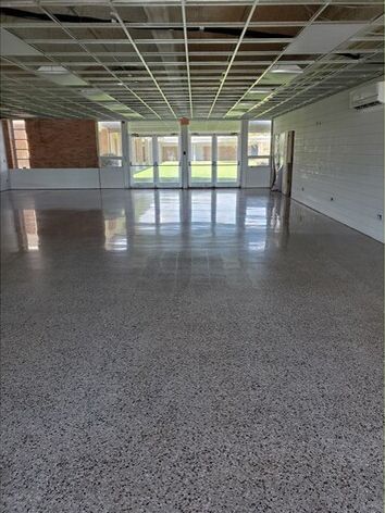 A large empty room with a shiny floor and ceiling.