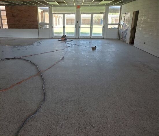 An empty room with a vacuum cleaner on the floor