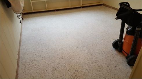 A vacuum cleaner is sitting on the floor of a room.