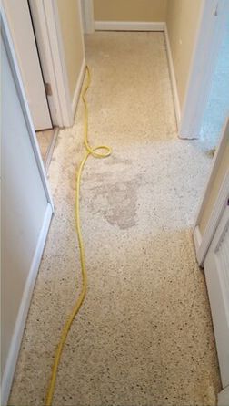A hallway with a yellow cord hanging from the ceiling.