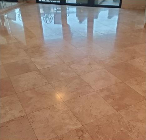 A marble floor with a reflection of a building in it.