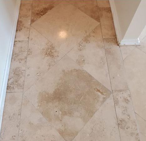A tiled floor with a diamond pattern in a hallway.