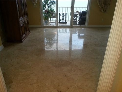 A living room with a tiled floor and a broom.