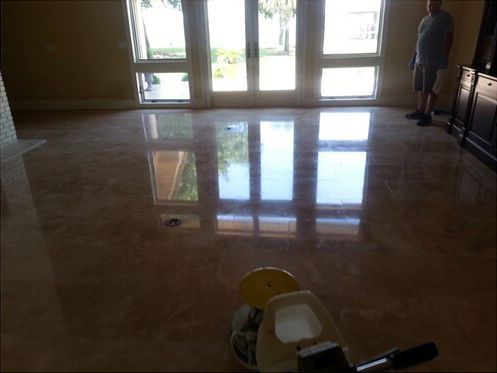 A man is standing in a room with a marble floor