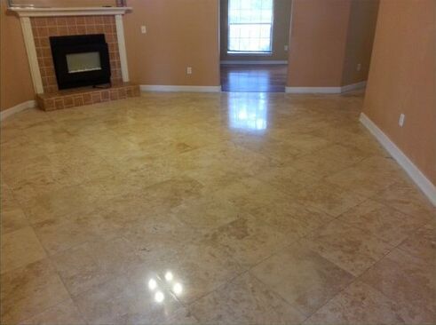 A living room with a fireplace and a tiled floor.