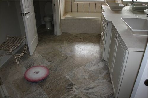 A bathroom with a toilet, sink, and bathtub.