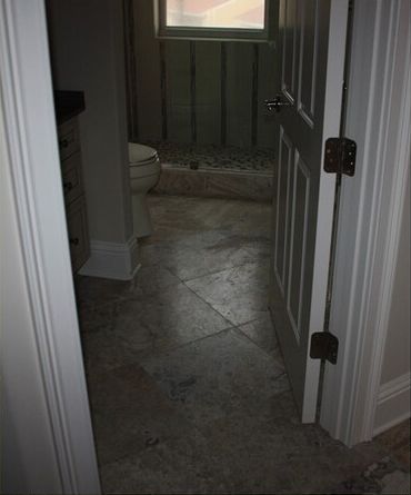 A bathroom with a toilet, sink, and shower.