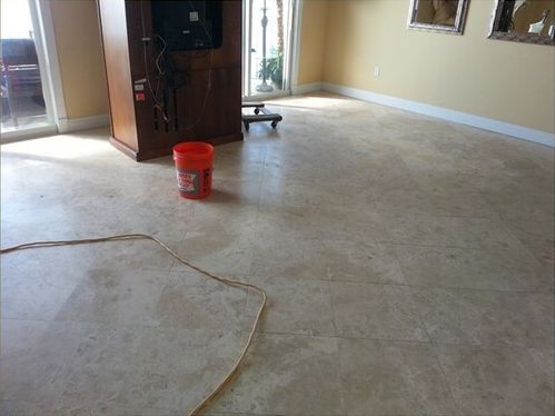 A living room with a red bucket on the floor
