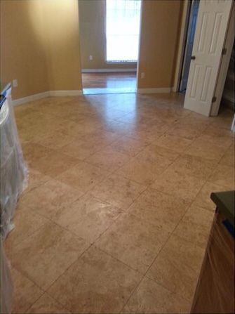 An empty room with a tiled floor and a window.