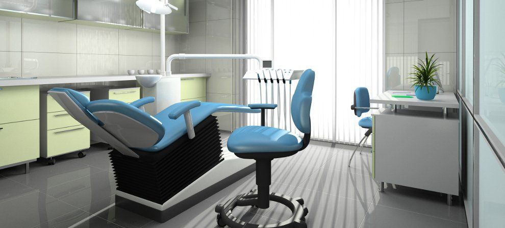 A dental office with a dental chair and a desk.