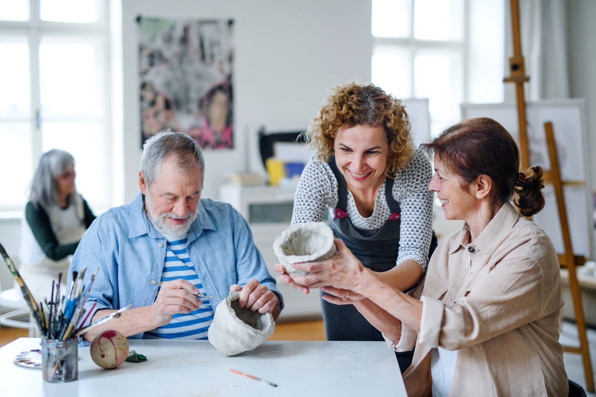 Old man and women working with clay | Adelaide, SA | Pristine Support Services