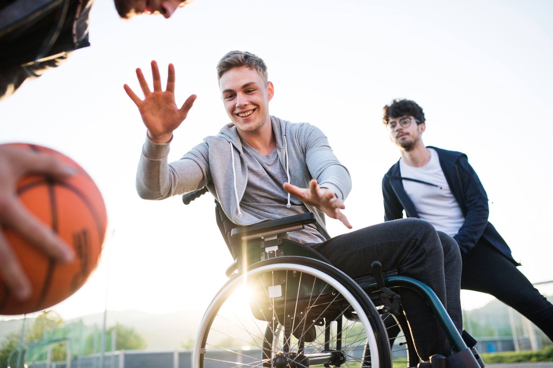 Boy in a wheelchair with teenager friends outside | Adelaide, SA | Pristine Support Services