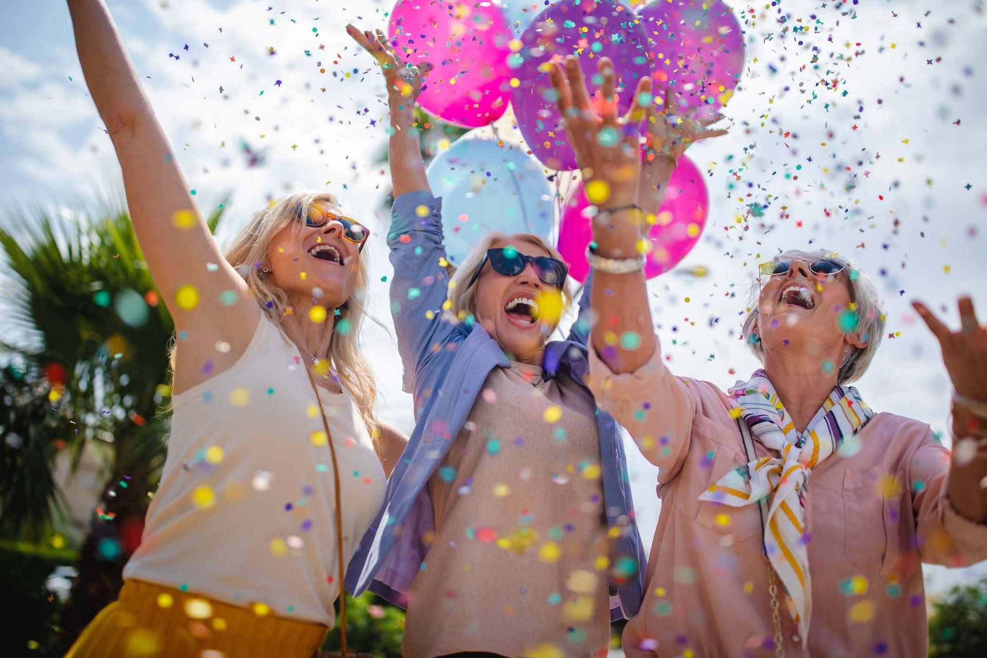 Mature women celebrating with colourful confetti and balloons | Adelaide, SA | Pristine Support Services