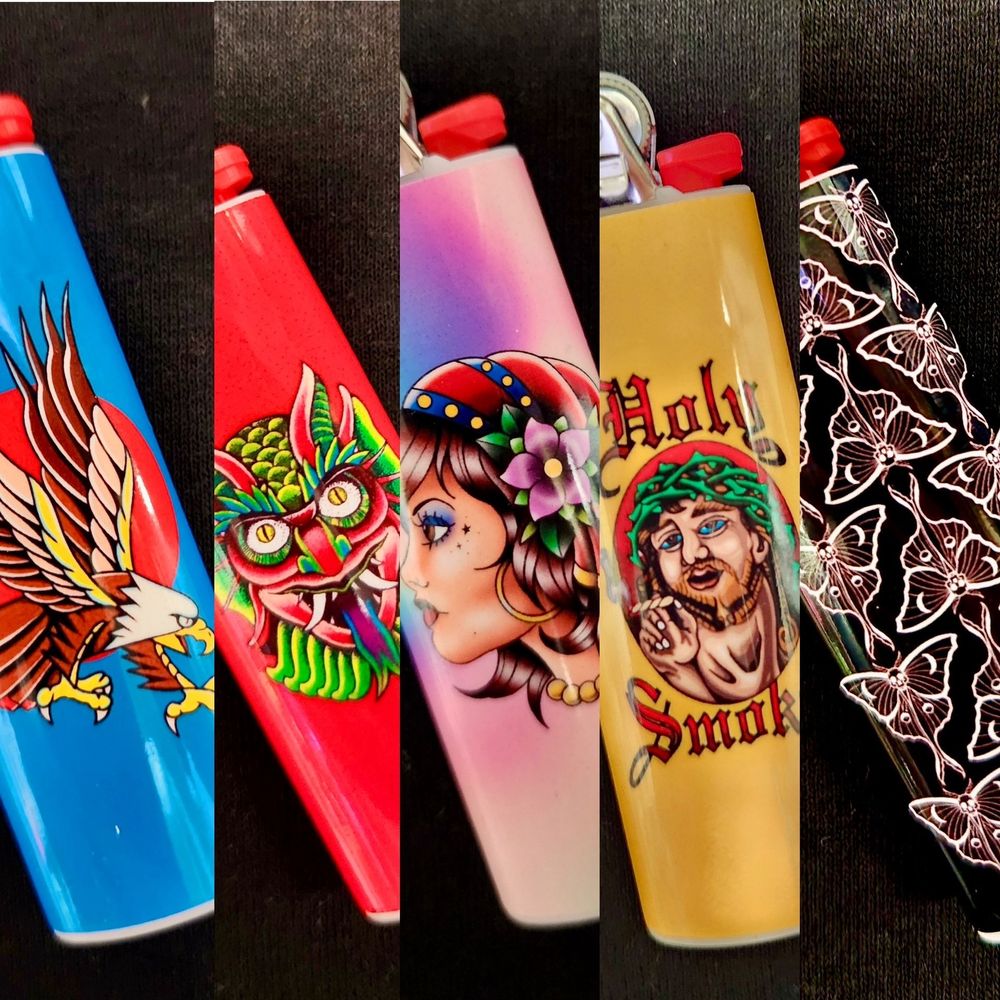 Resurrection Ink custom lighters, available in Eagle, Lizard Man, Gypsy, Holy Smokes, and Moths designs