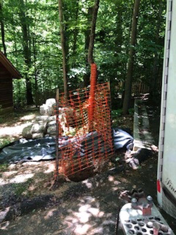Fence Is Surrounding a Pile of Rocks