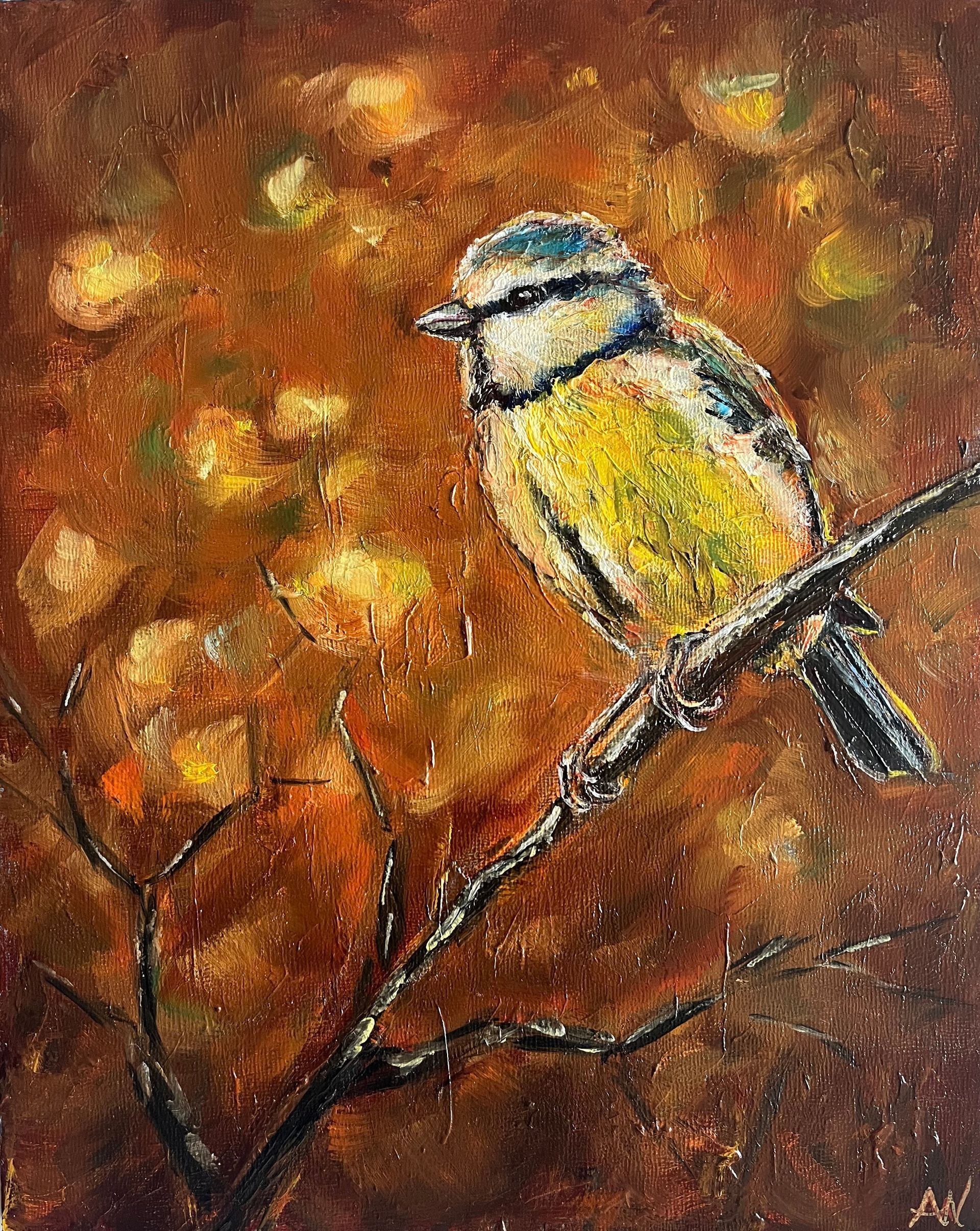 Blue, yellow, and white bird perched on a branch, set against a warm, autumnal background with soft, blurred shapes.