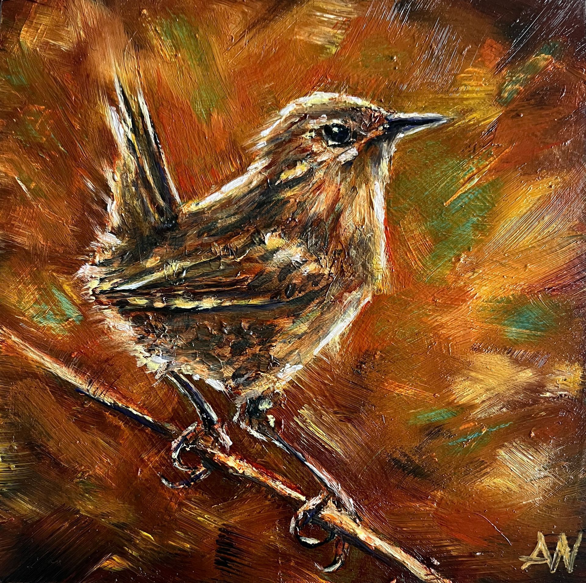 A small brown bird perched on a twig, set against a blurred background of autumn colors.