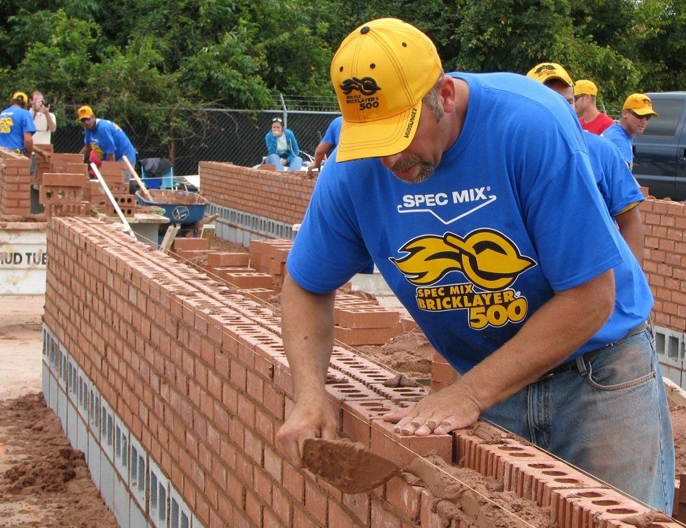 Man Building a Brick Wall in a Event — NC & SC — Tucker-Kirby Co.
