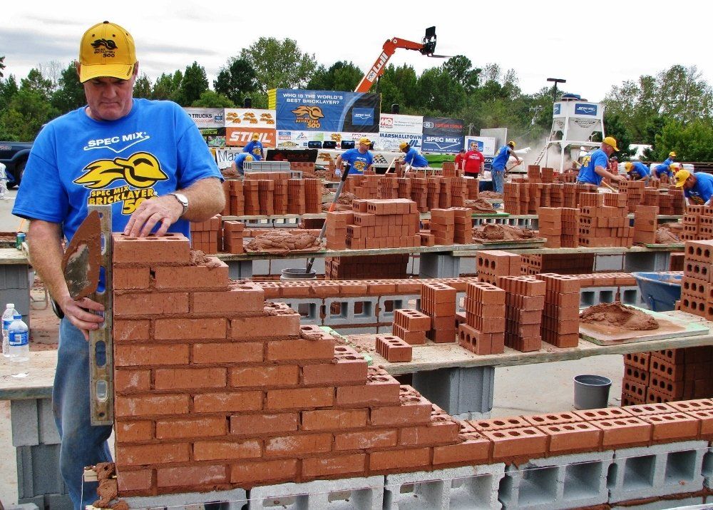 Man Checking the Measurements of the Bricks — NC & SC — Tucker-Kirby Co.