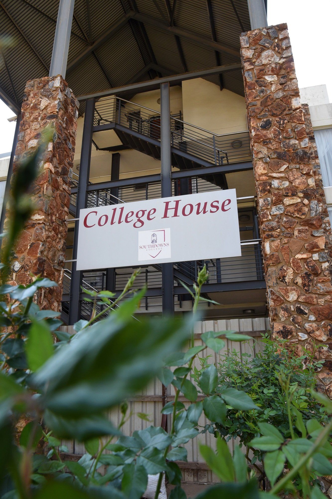 A sign on the side of a building that says college house