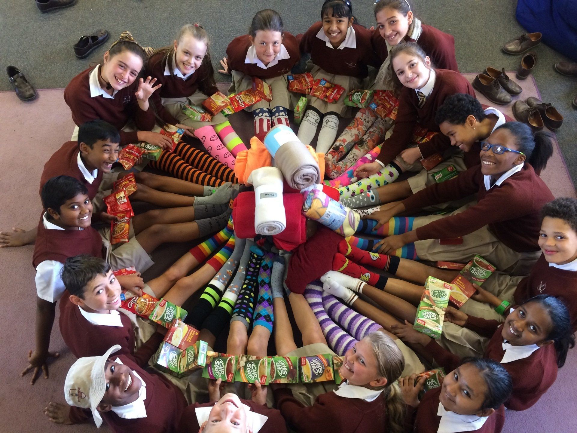 A group of children are sitting in a circle with socks on their feet