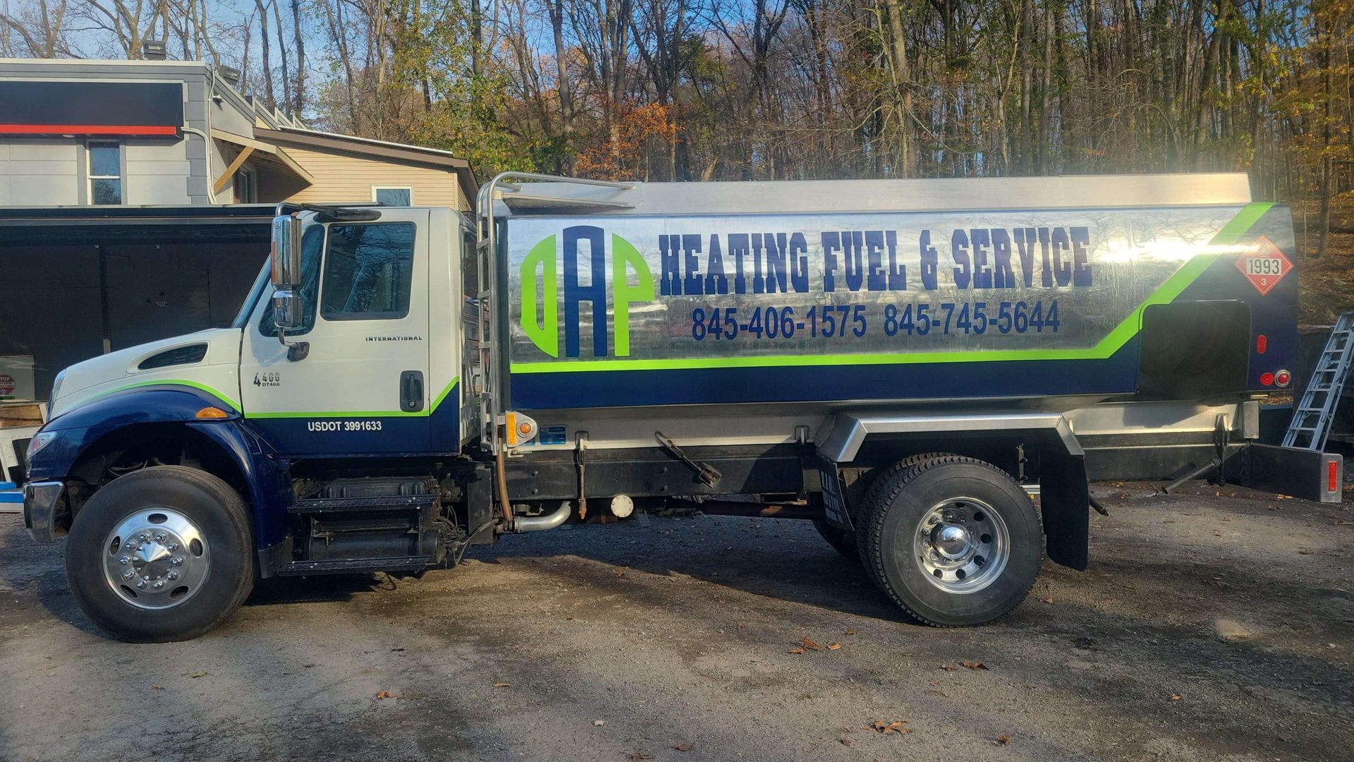 A heating fuel and service truck is parked in a parking lot.