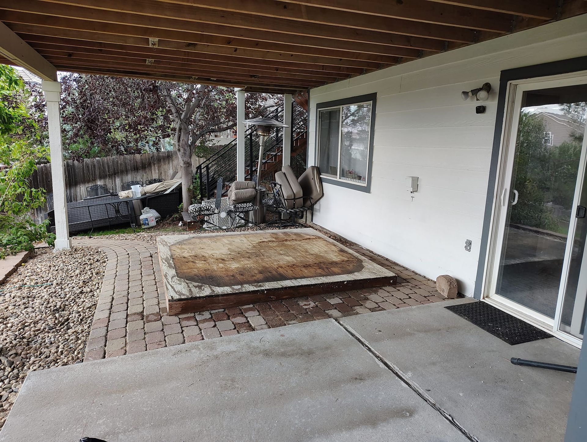 A white house with a covered patio and a sliding glass door.