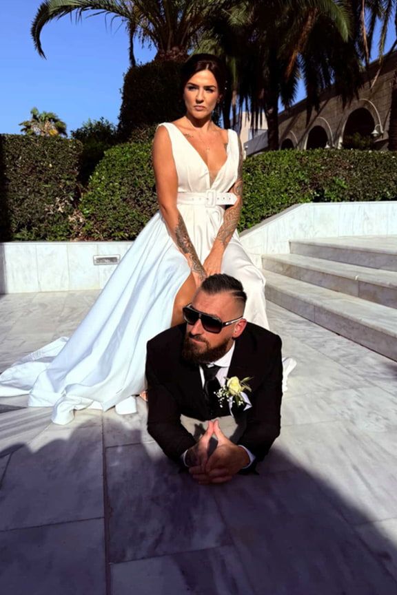 A Bride and Groom Are Posing for a Picture on Their Wedding Day — Eternal Weddings & Couture In Woolner, NT