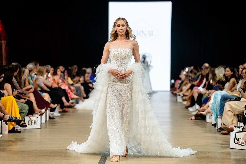 A Model is Walking Down the Runway at a Fashion Show Wearing a Wedding Dress — Eternal Weddings & Couture In Woolner, NT